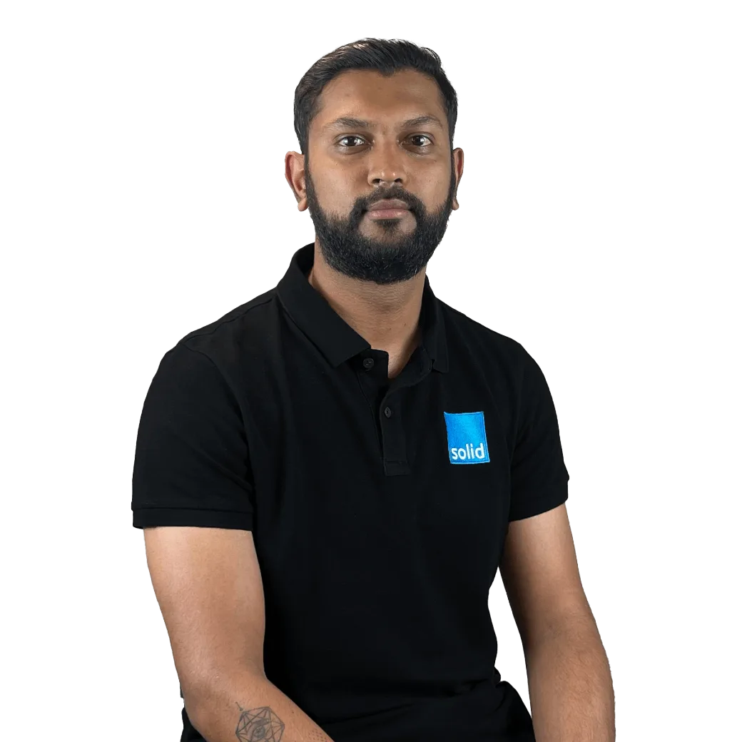 Bevin from the Solid Systems team, smiling in a Solid polo shirt