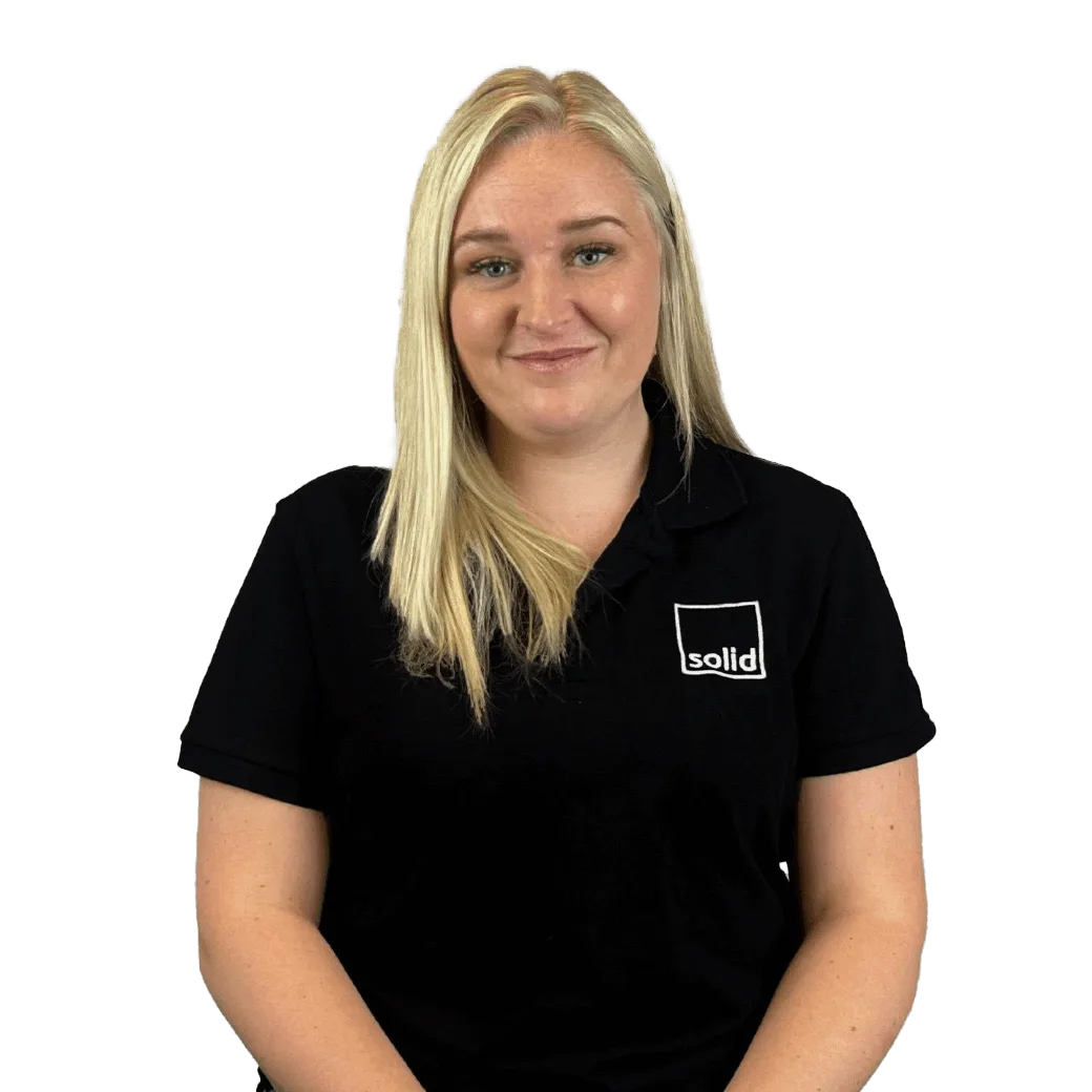 CJ from the Solid Systems team, smiling in a Solid polo shirt