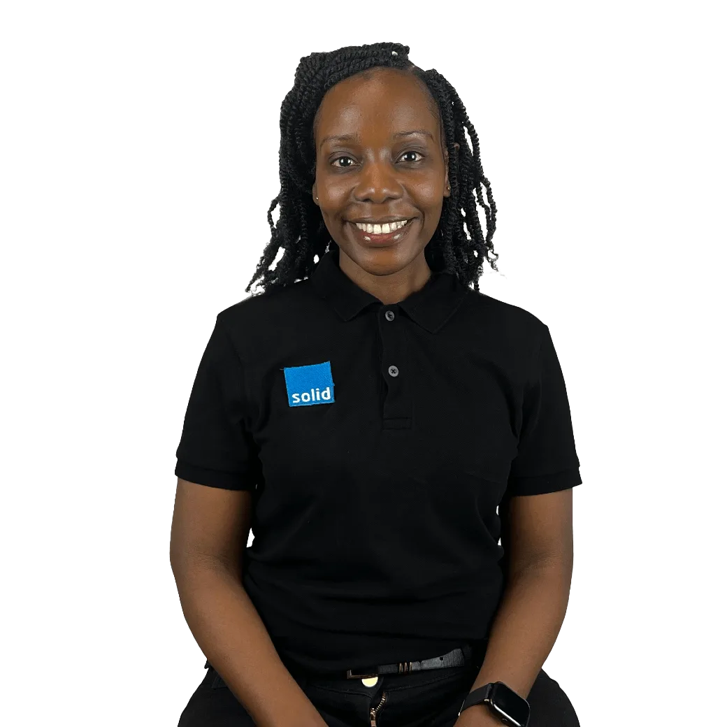 Melinda from the Solid Systems team, smiling in a Solid polo shirt