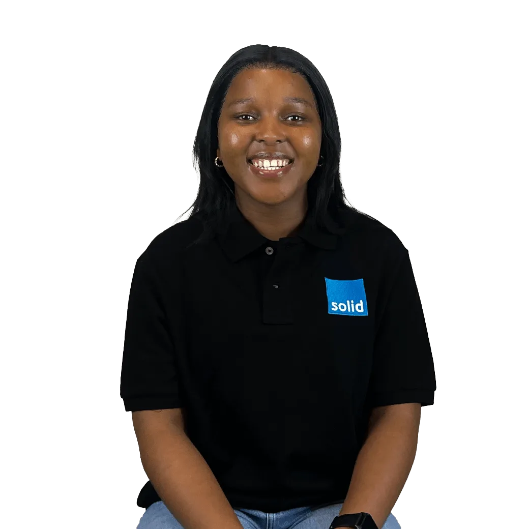 Nandi from the Solid Systems team, smiling in a Solid polo shirt