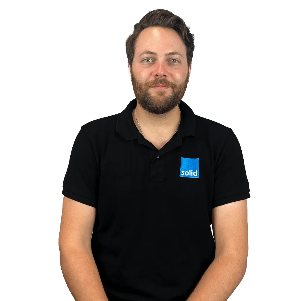 Waldo from the Solid Systems team, smiling in a Solid polo shirt