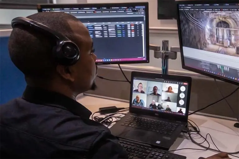 A Solid Systems IT Pro on a Microsoft Teams call at a multi-screen desk