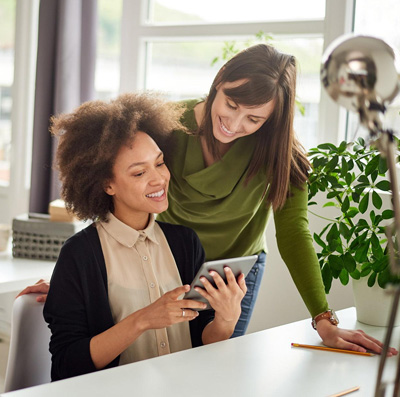 Two colleagues looking at a tablet together