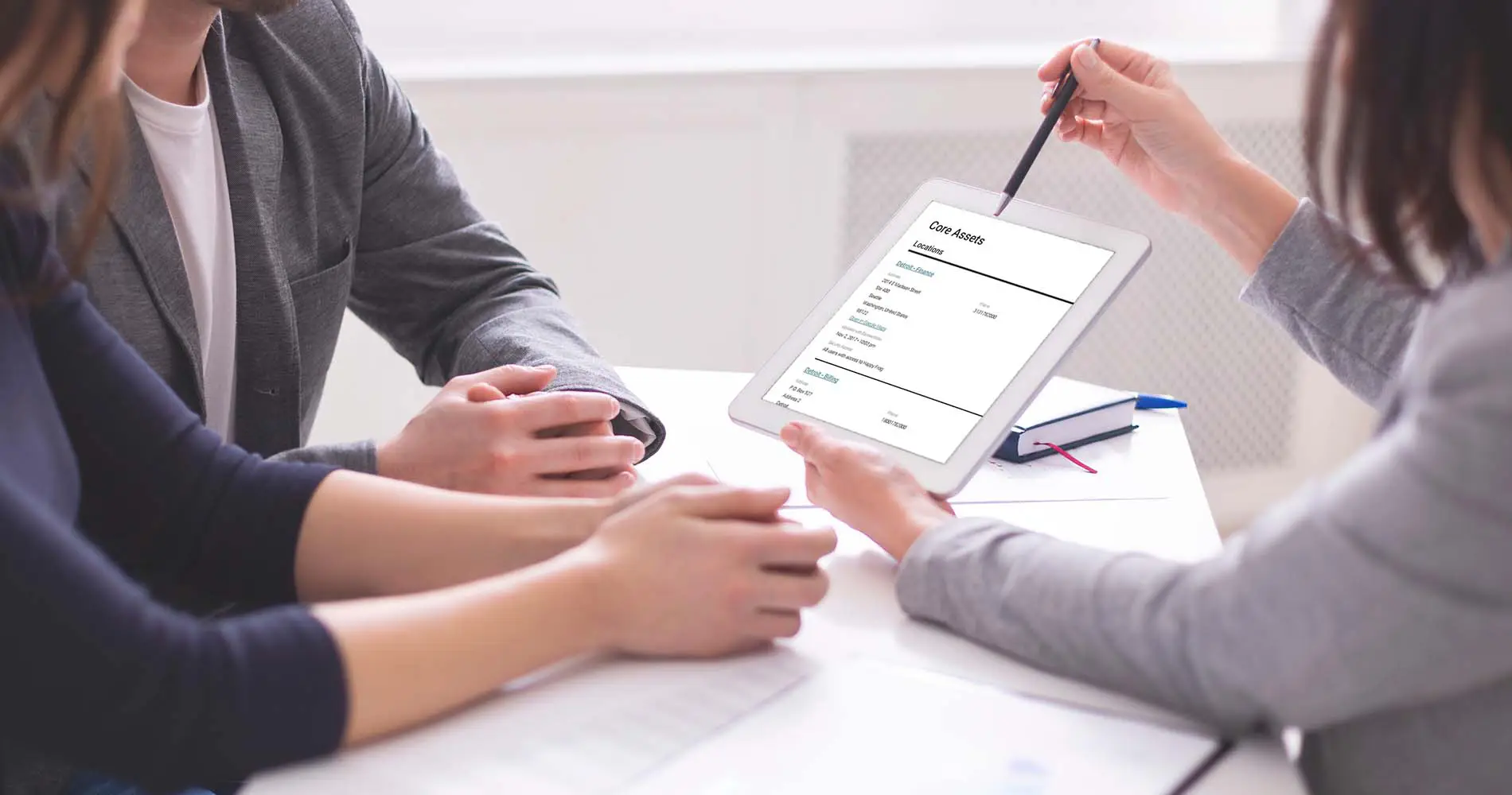 A Solid Systems consultant taking a client through their review findings on a tablet